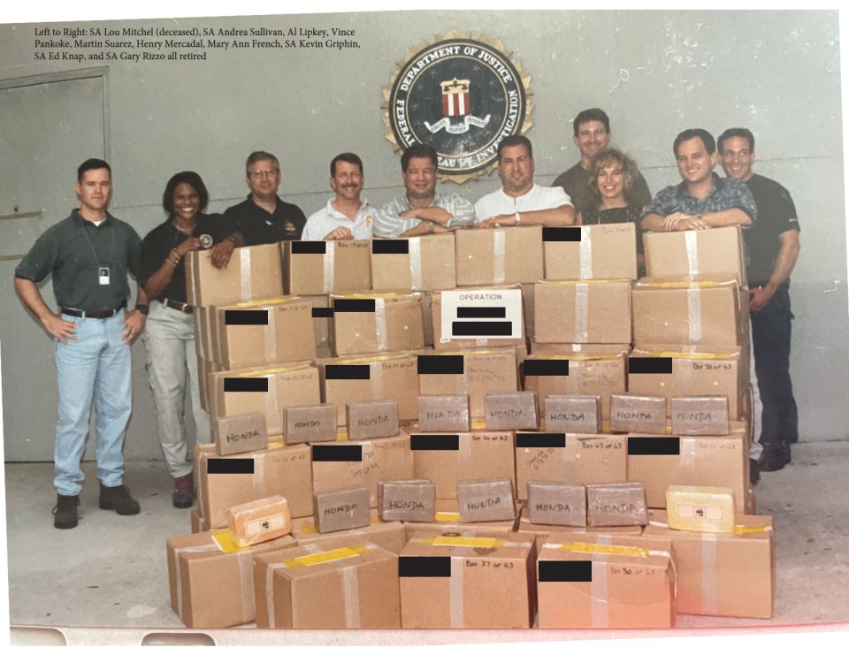 FBI agents pose with boxes of seized items.