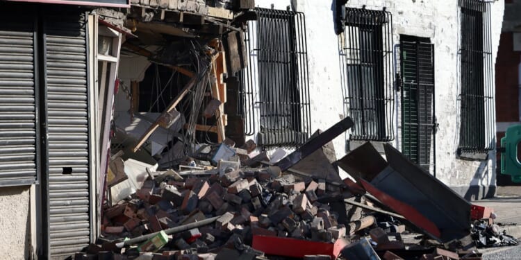 Town centre building collapses after car smashes into takeaway during police chase before man in his 30s arrested – The Sun