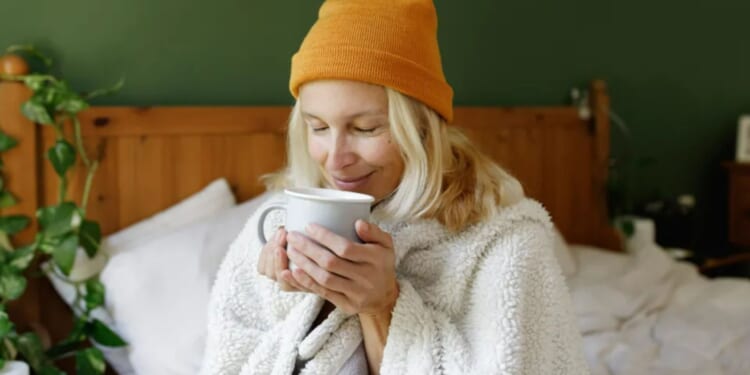 Eight ways to keep warm all night without turning the heating on - including the free trick that'll stop draughts