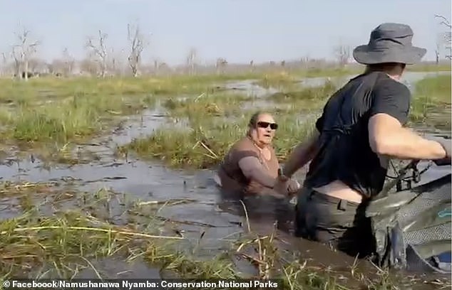 The couples had a lucky escape and were left in crocodile-infested waters. The woman who was attacked manages to get to her knees  as her husband wades to her and grabs her hand, and guides her to safety