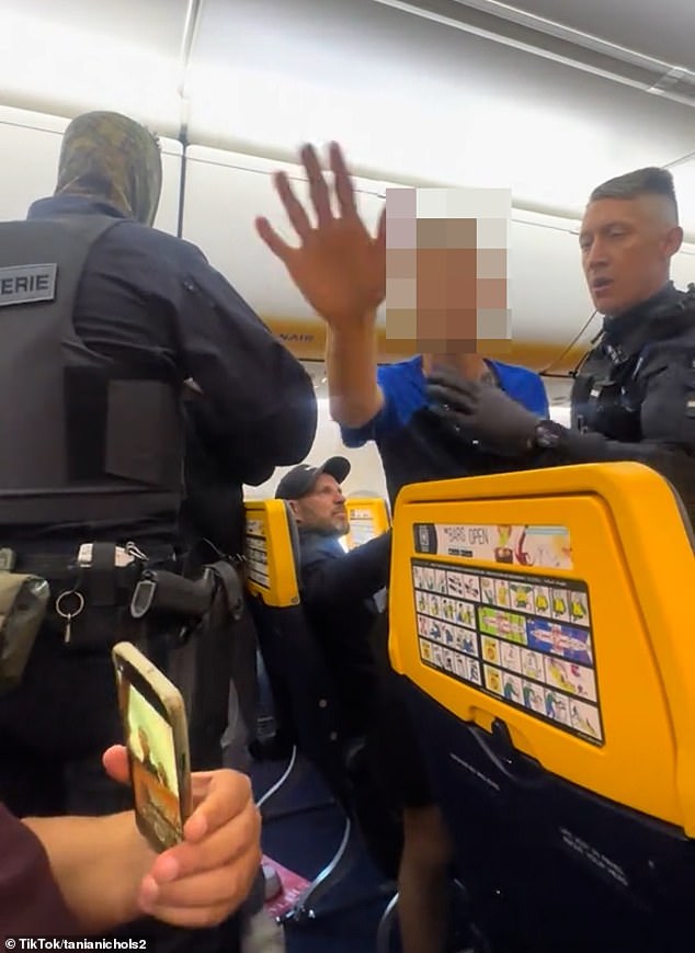 As one of the officers eventually gets the passenger in an upright position, they become embroiled in a verbal altercation as his younger son stands up and tells the cops: 'He didn't start that, they started it, my dad did not start that'