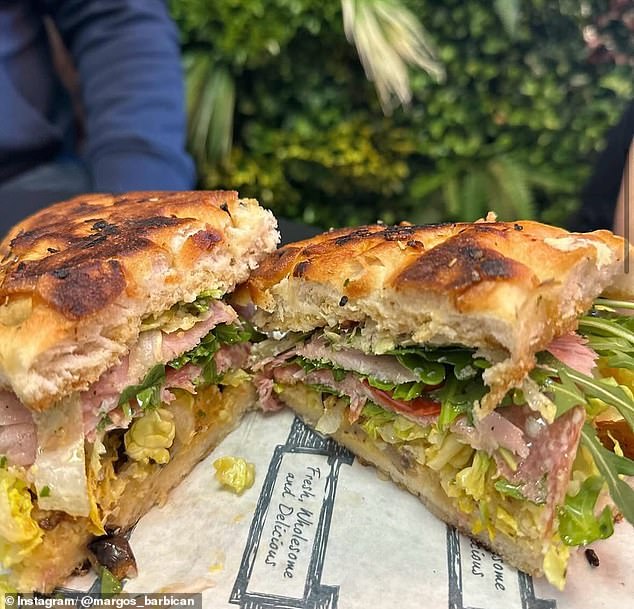 The cafe is nestled in an assuming white building along a cobblestone street and has cabinets of cakes and quiches, but is best known for its breakfast, toasted, and special sandwiches