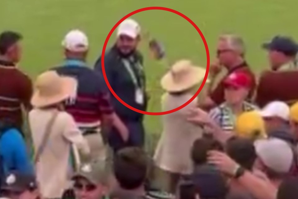 Patrick Cantlay's caddie Joe LaCava being splashed with water by a spectator.