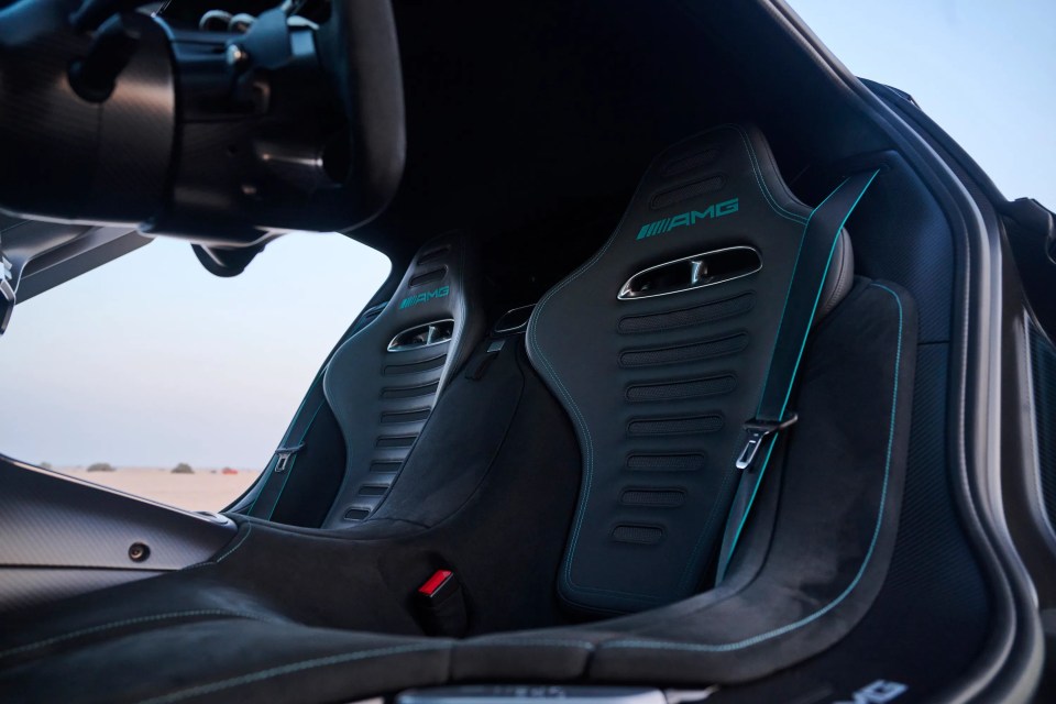 Black Alcantara bucket seats with teal accents in a Mercedes-AMG ONE.