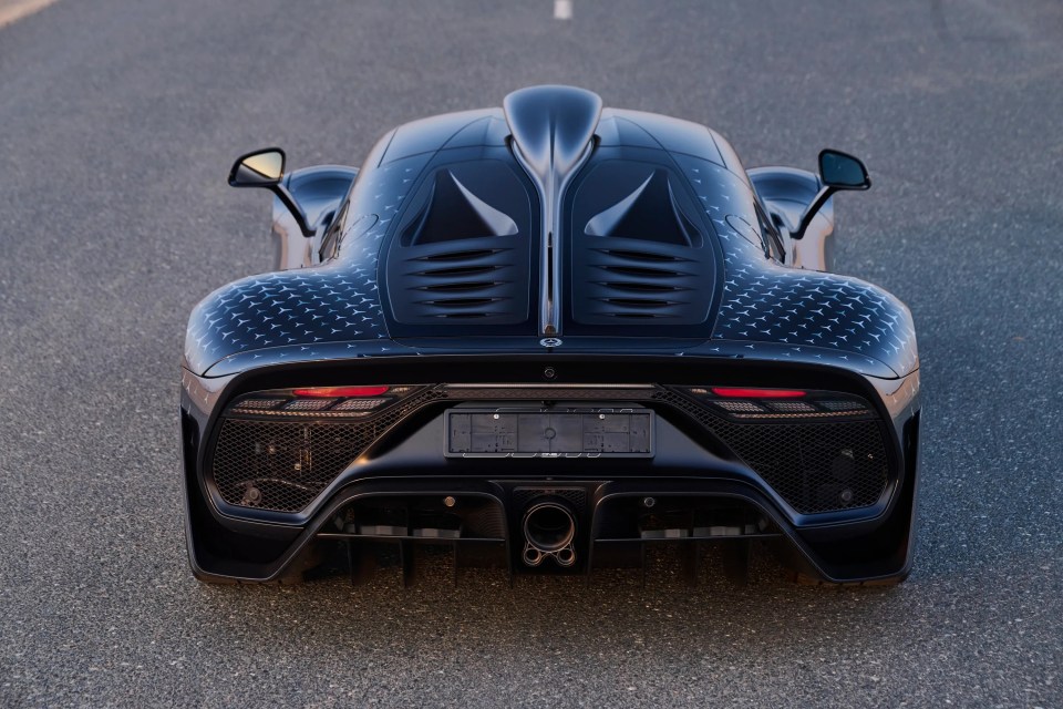 The rear of a black Mercedes-Benz AMG ONE with STAR Motorsport graphics.