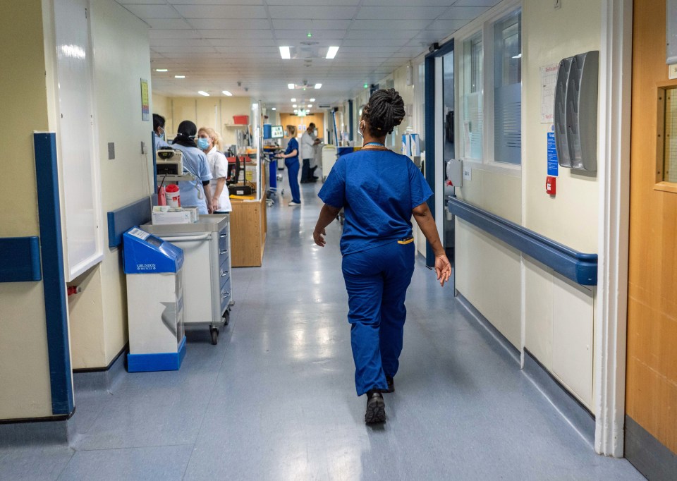 NHS hospital ward with nurses and medical equipment.