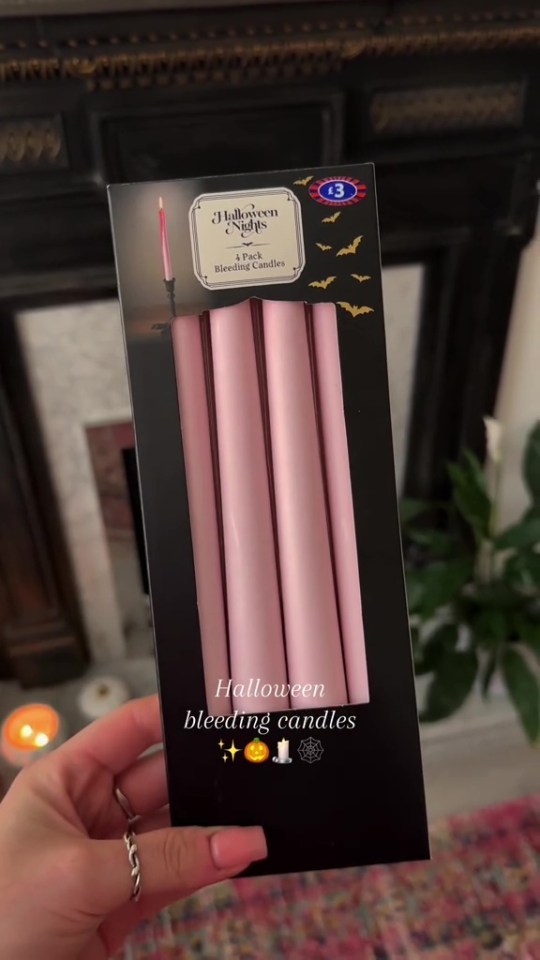 A hand holding a package of four pink "Halloween Nights 4 Pack Bleeding Candles" with a price tag of £3.