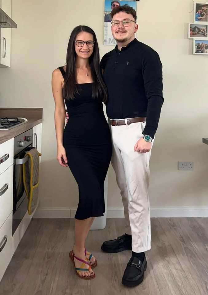 Georgia and Laurence posing together in a kitchen.