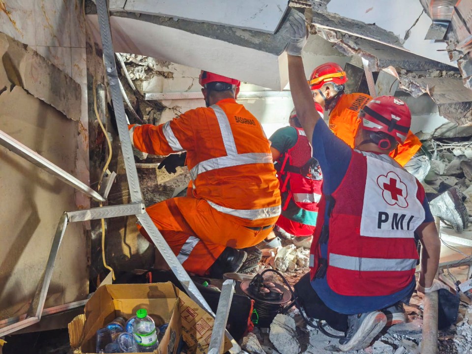 Rescuers searching for victims in a collapsed prayer building at an Islamic boarding school in Sidoarjo, East Java, Indonesia.