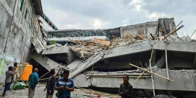 Frantic rescue as school collapses leaving at least one student dead and dozens trapped under the rubble in Indonesia