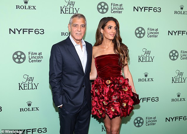 Amal was a vision in a red mini dress featuring a velvet top and floral infused skir