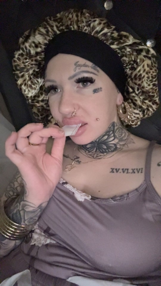 Yaz Chapman holding a piece of paper to her mouth.