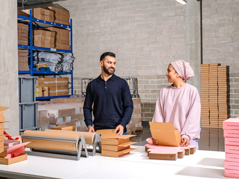 Two people packing orders in a warehouse.