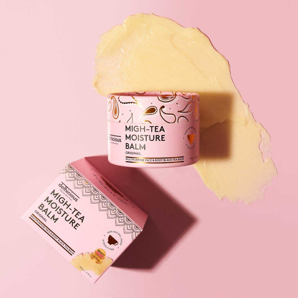 Delhicious Migh-Tea Moisture Balm in its packaging, with a dollop of the product on a pink background.