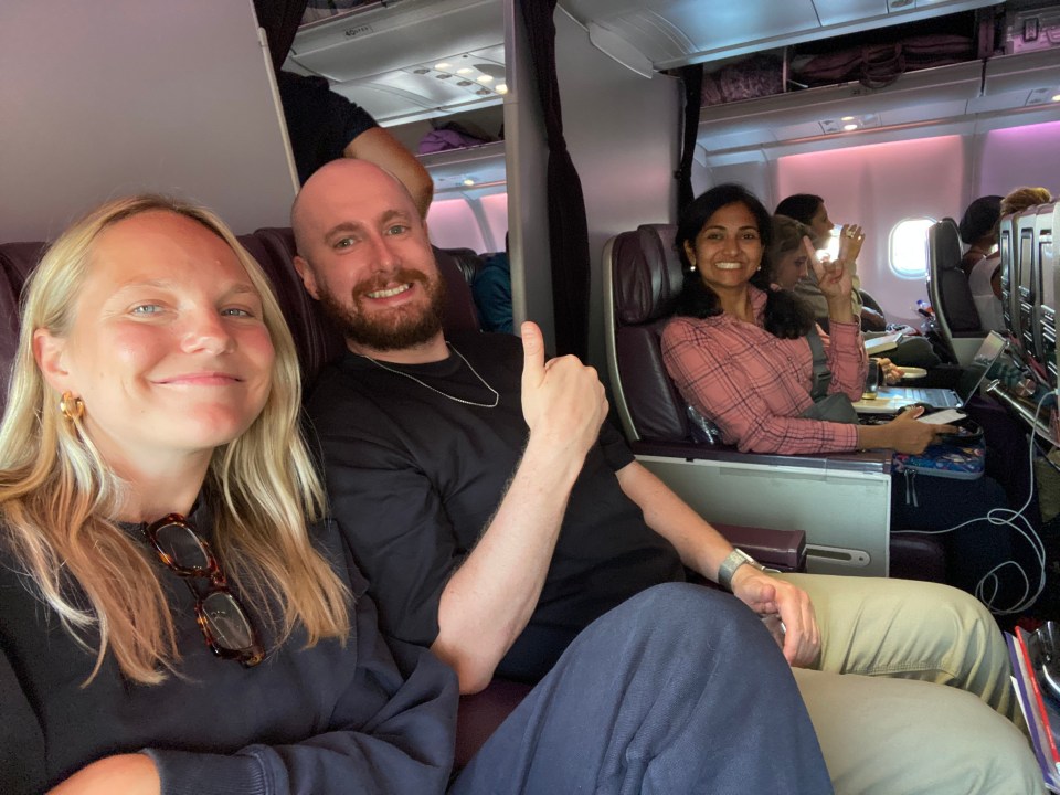 Photo of three people seated on an airplane.