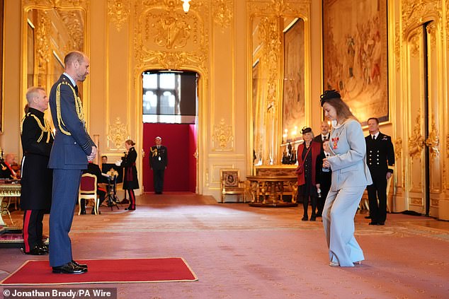 The actress, 48, who looked elegant in a blue suit, received the honour from the Prince of Wales in a nod to her services to drama and to charity