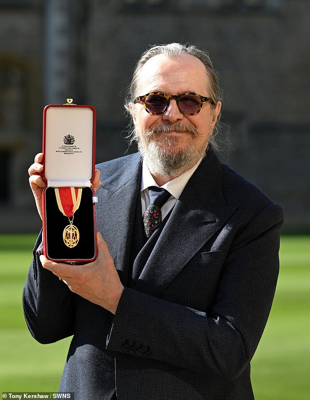 Sir Gary posed with his honour at the grounds of Windsor Castle
