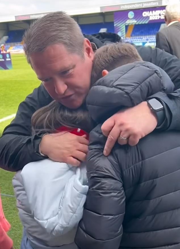 Matt hugging his children after a Liverpool match