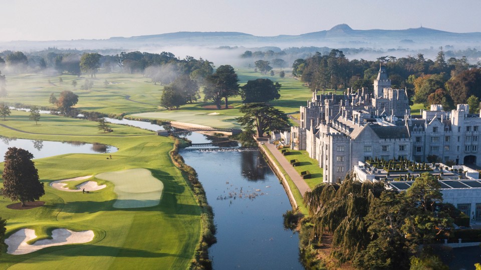 Aerial view of the Adare Manor golf course and hotel with mist in the background.