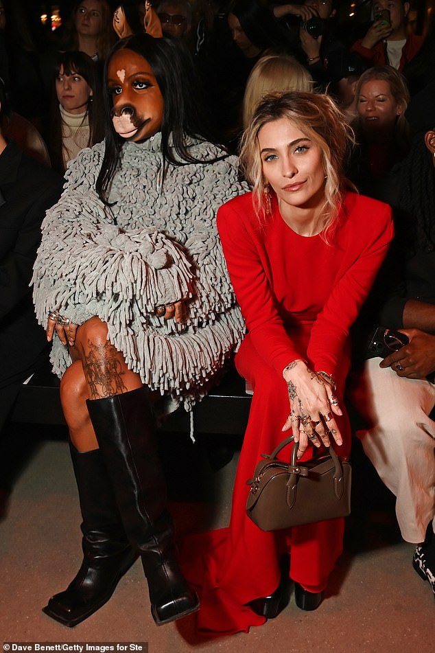 Paris was seated on the front row alongside an unlikely guest, Horsegirl
