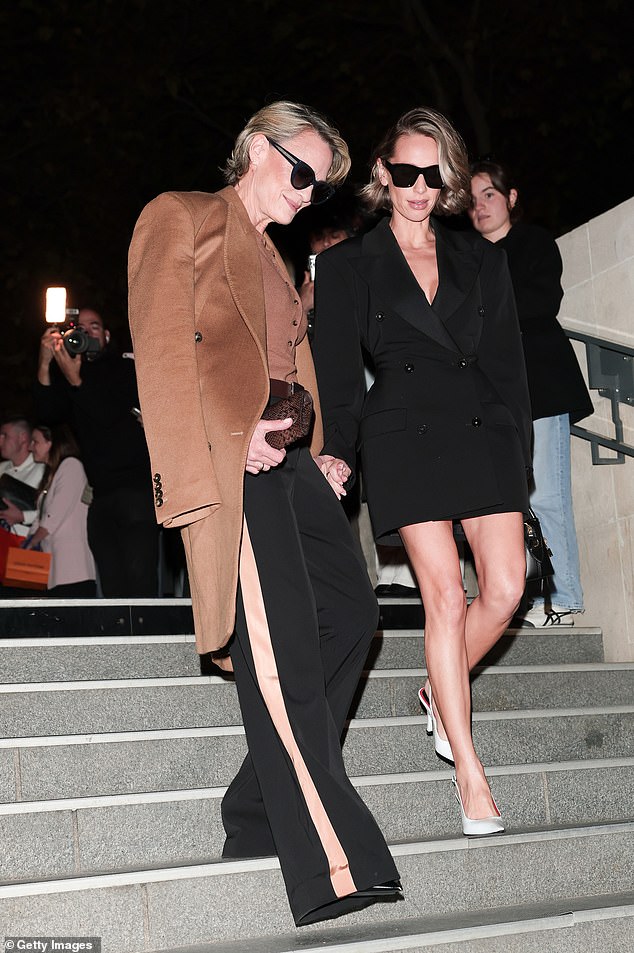 Dylan put on a leggy display in a chic black blazer mini dress and white satin heels as she joined her famous mother at the fashion show