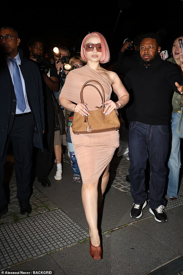 Accessorising her look with matching heels and a brown suede handbag, the performer put on an eye-catching display at the show