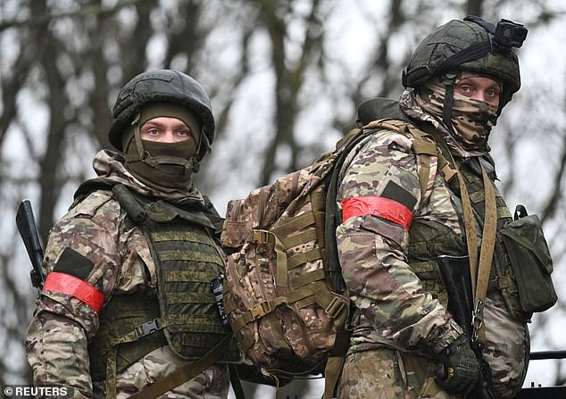 Young Russian males are pictured receiving combat training after being conscripted last year