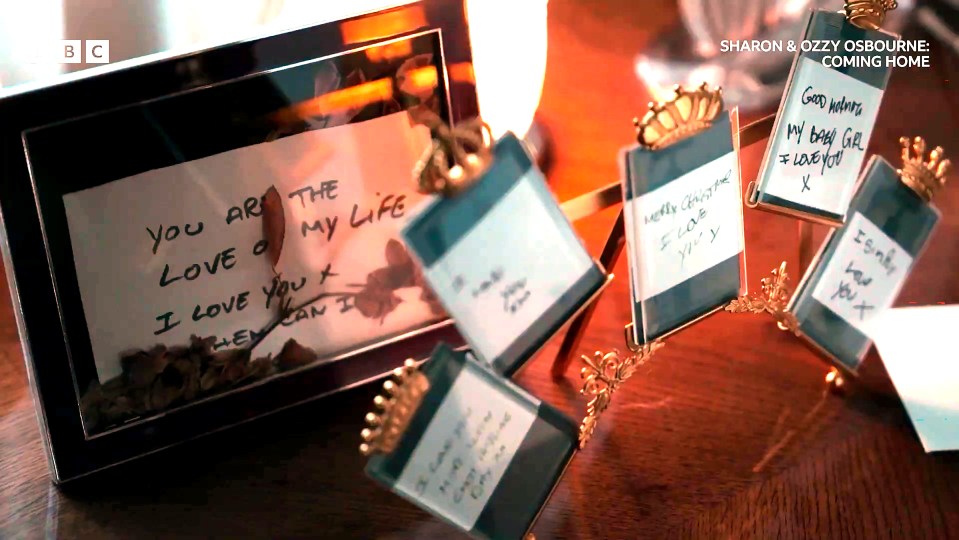 A framed note with "YOU ARE THE LOVE OF MY LIFE I LOVE YOU X" and a connected chain of small, crowned frames containing handwritten notes.