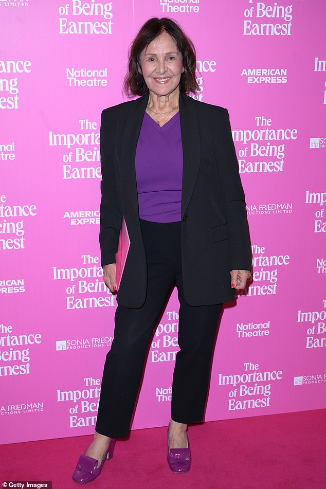 Dame Arlene, 82, opted for a black suit for the evening out, though added a purple jumper underneath to bring a pop of colour
