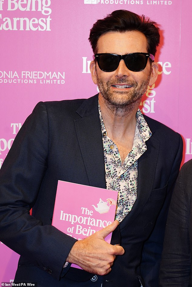 Actor David Tennant was also snapped on the carpet, wearing black shades, as he clutched the show's official program ahead of the performance