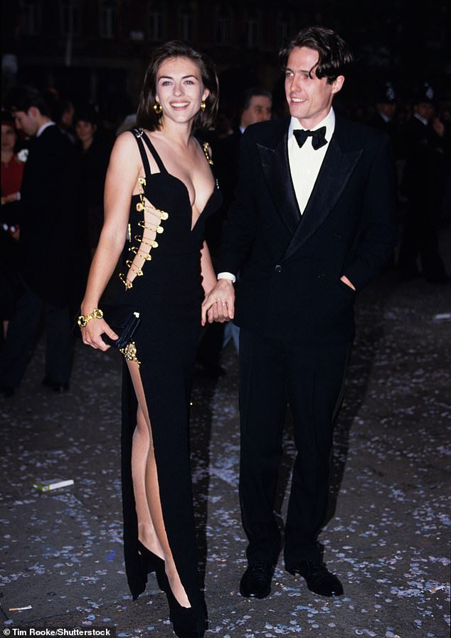 Elizabeth pictured with Hugh in 1994 in her iconic safety pin dress at the Four Weddings And A Funeral premiere. She still looks in just as good shape