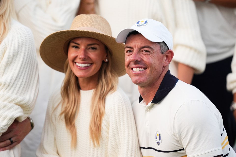 Rory McIlroy and Erica Stoll smiling at the 2025 Ryder Cup.