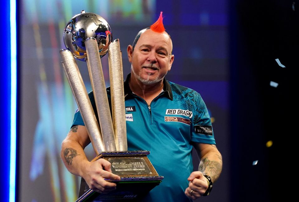 Peter Wright holding the Sid Waddell Trophy.