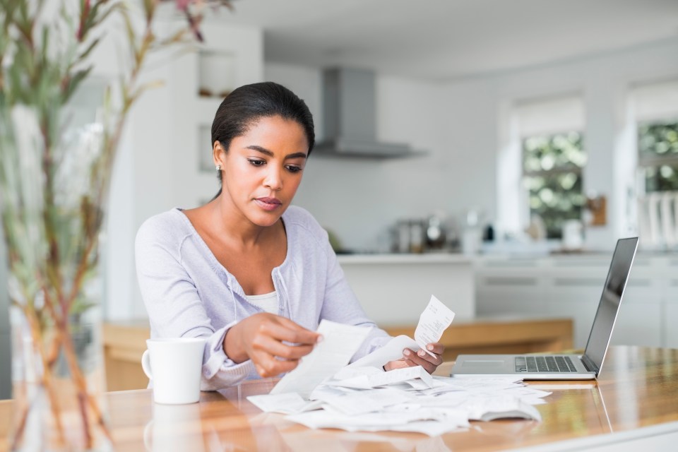 Woman reviewing bills at home.