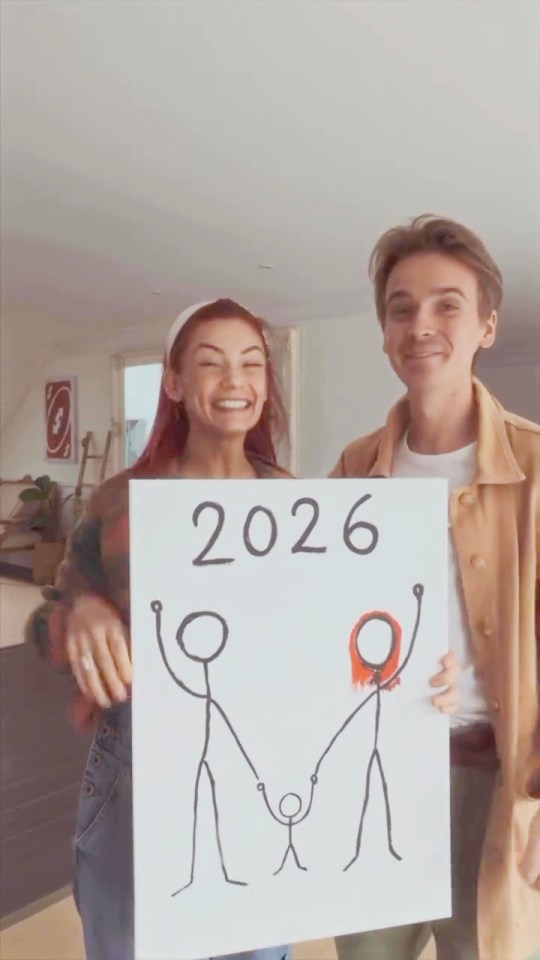 Dianne Buswell and Joe Sugg holding a sign announcing their pregnancy in 2026.