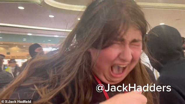 One woman reeling away in agony after being caught by the pepper spray