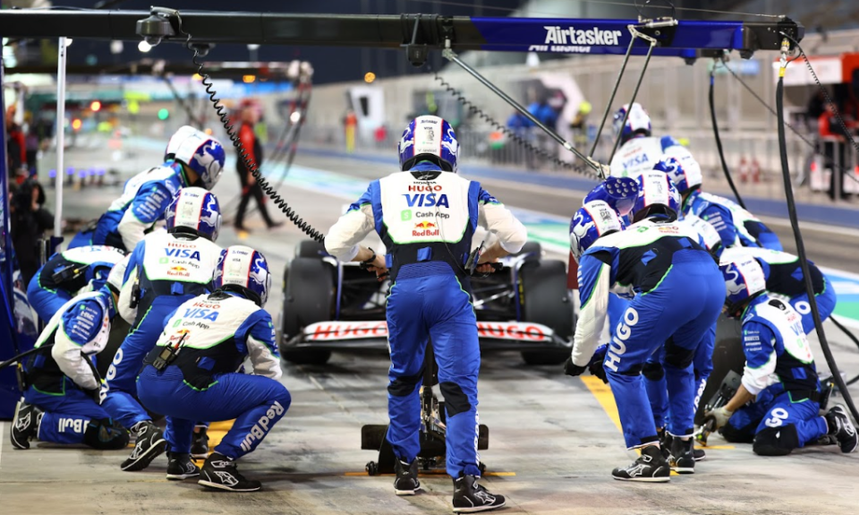 Pit crew working on a Formula 1 race car.