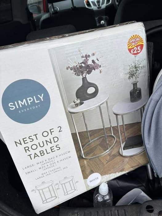 Box of two white round nesting tables.