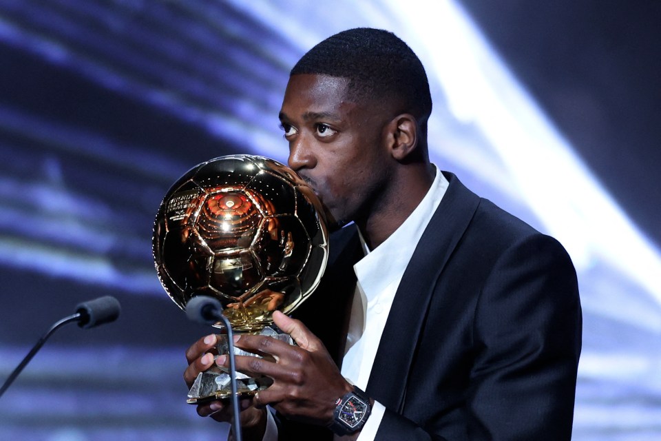 Ousmane Dembele kissing the Ballon d'Or award.