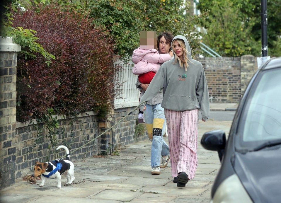 Billie Piper and Johnny Lloyd walking their dog with their daughter.