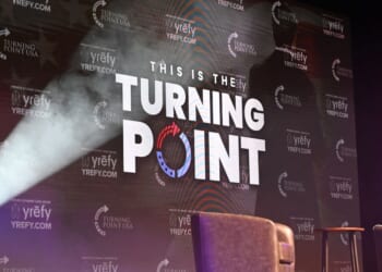 The Turning Point USA logo is displayed on stage at Burruss Hall at Virginia Tech University in Blacksburg, Virginia, on Sept. 24, 2025.