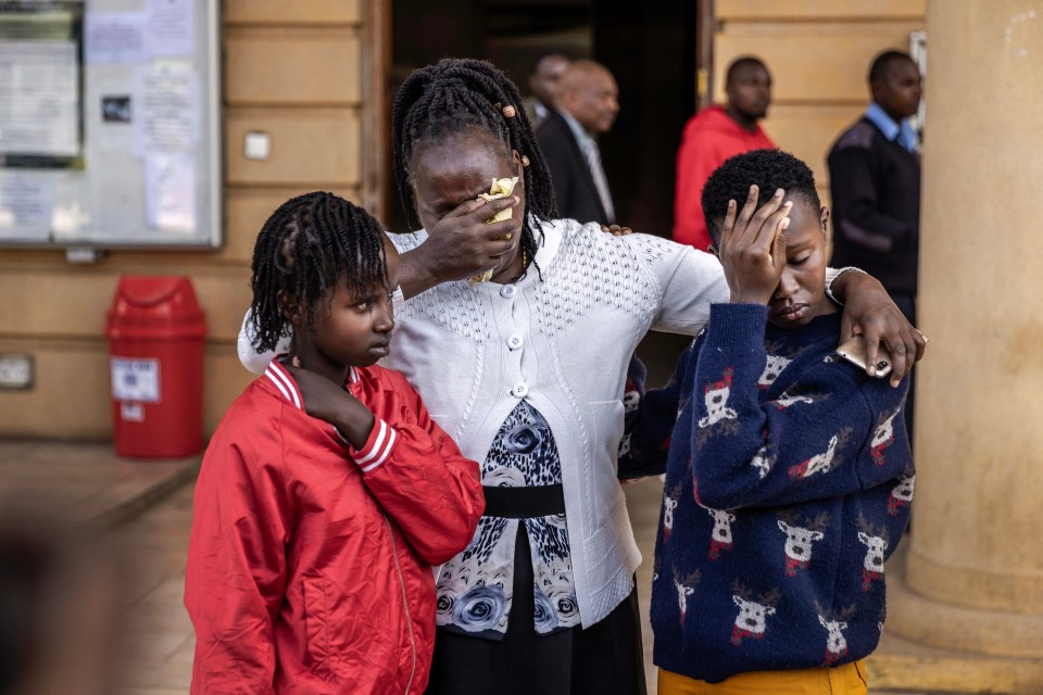 Agnes Wanjiru's daughter Stacy Wanjiru (left), sister Rose Wanyua (center), and niece Esther Njoki (right) hug after a court hearing.