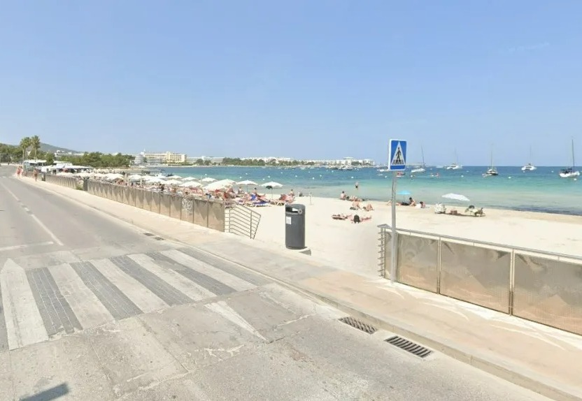 Street view of a beach with people sunbathing.