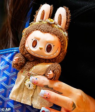 Genuine Labubu dolls from Pop Mart have a distinctive elf-like design and include authenticity markers