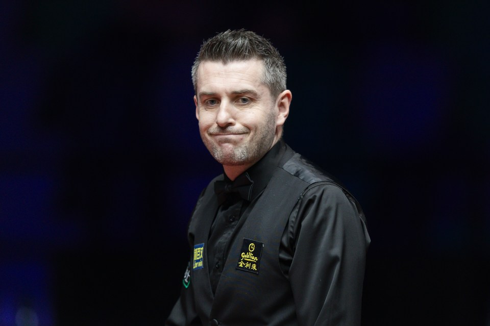 Mark Selby of England reacts during a snooker match.
