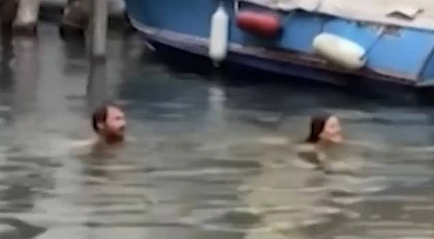 The 35-year-old man and his 25-year-old Romanian partner, who live in the UK, were reportedly taking a dip in the canal when they were spotted by gondoliers and reported to police