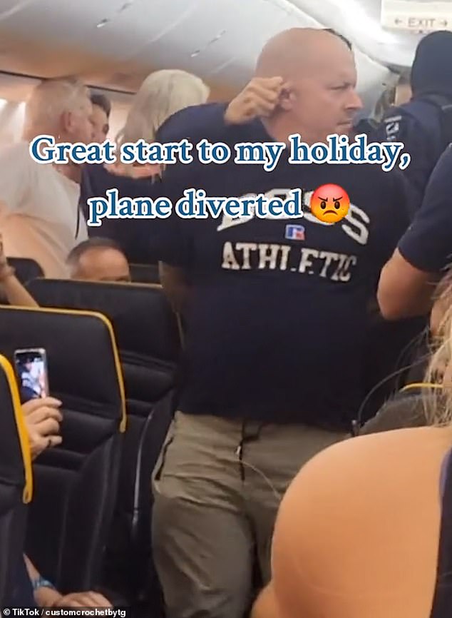 Another video showed a passenger being dragged away by his ear by a cop on board the flight