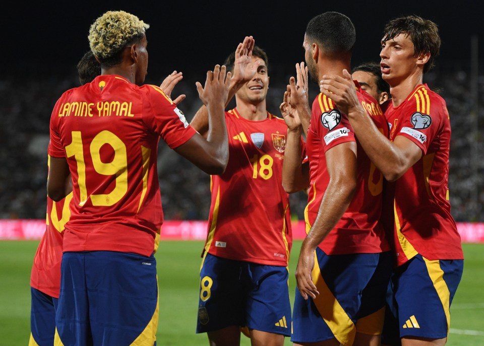 Spanish soccer players celebrating a goal.