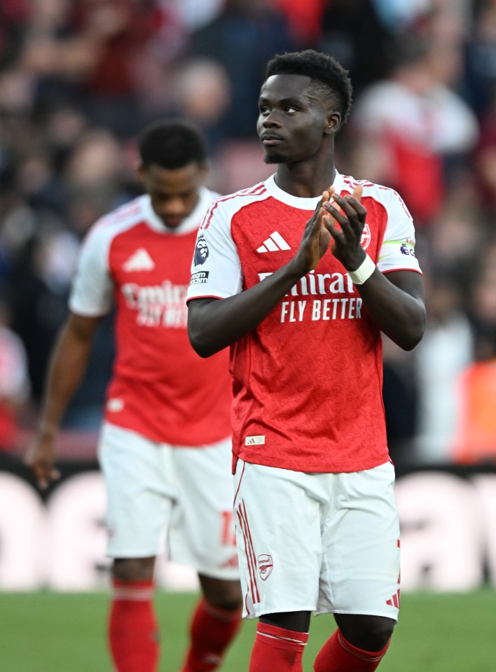 Bukayo Saka applauds fans after a match between Arsenal and Manchester City.