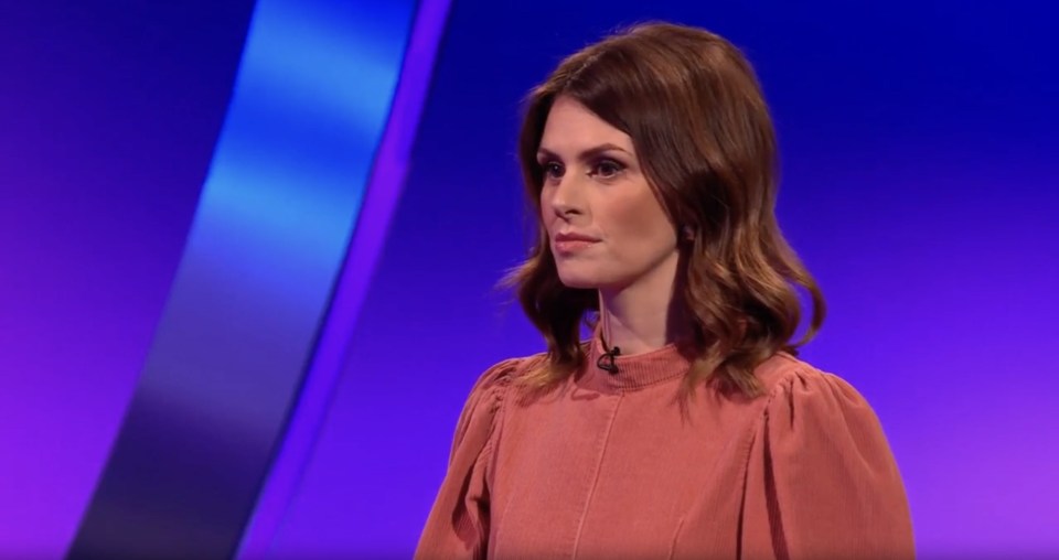 Ellie Taylor in a coral top.